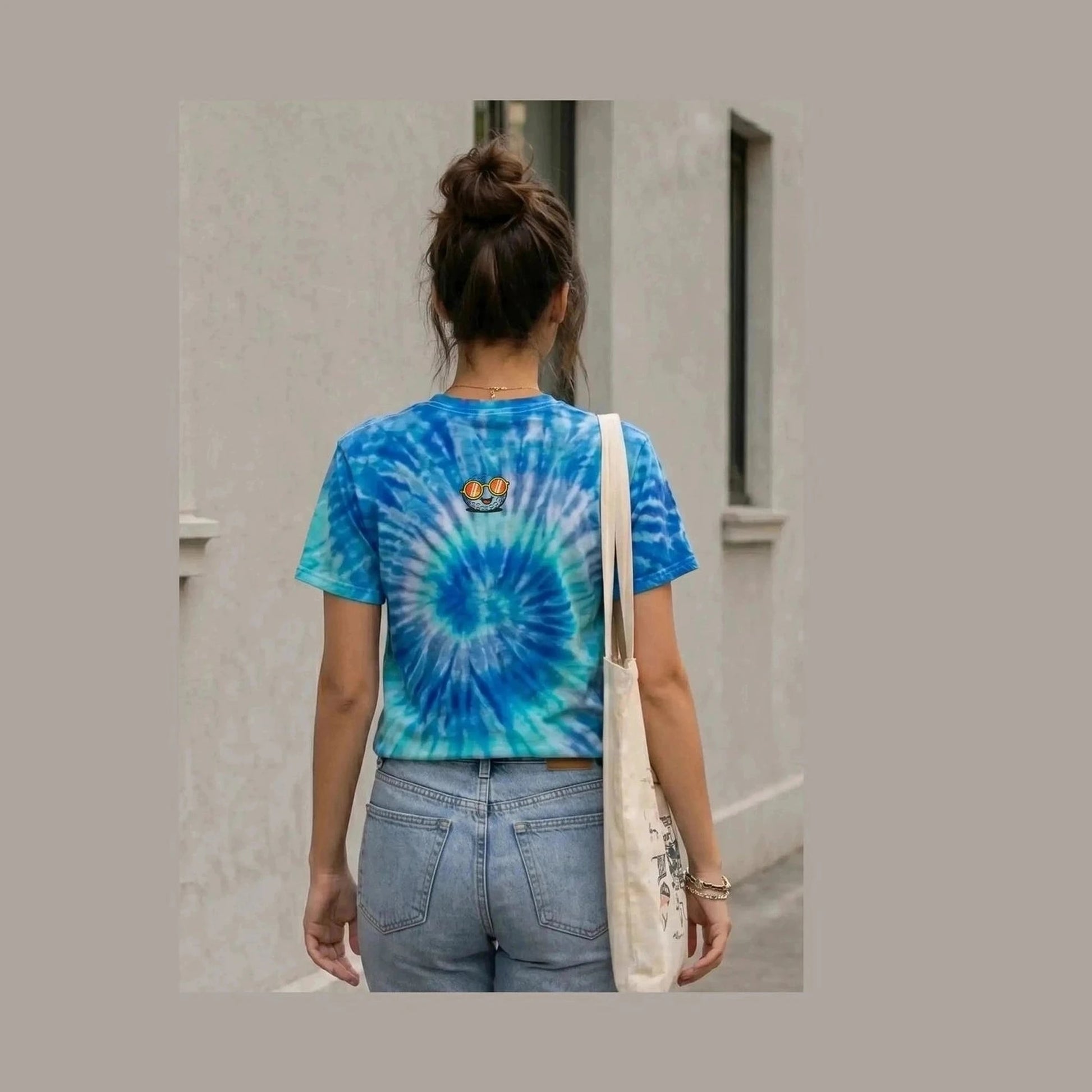 Rear view of blue tie-dye golf shirt with cartoon golf ball logo