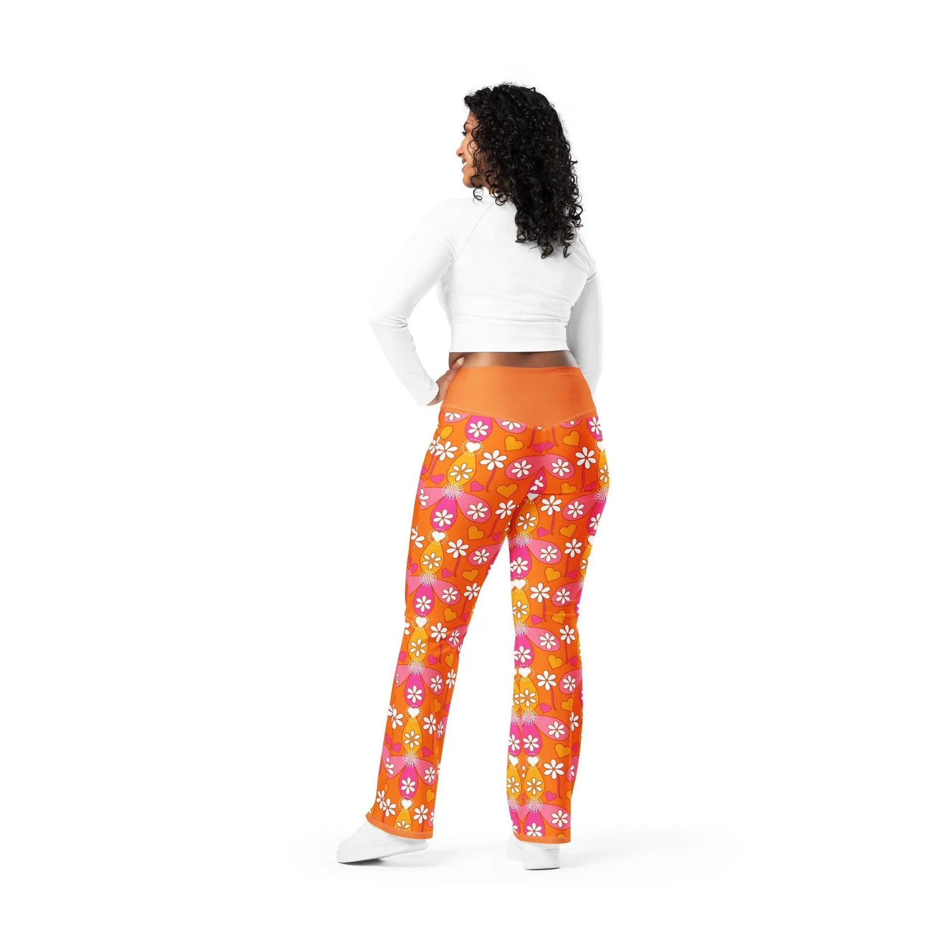 Model in orange high-rise heart pattern flare leggings
