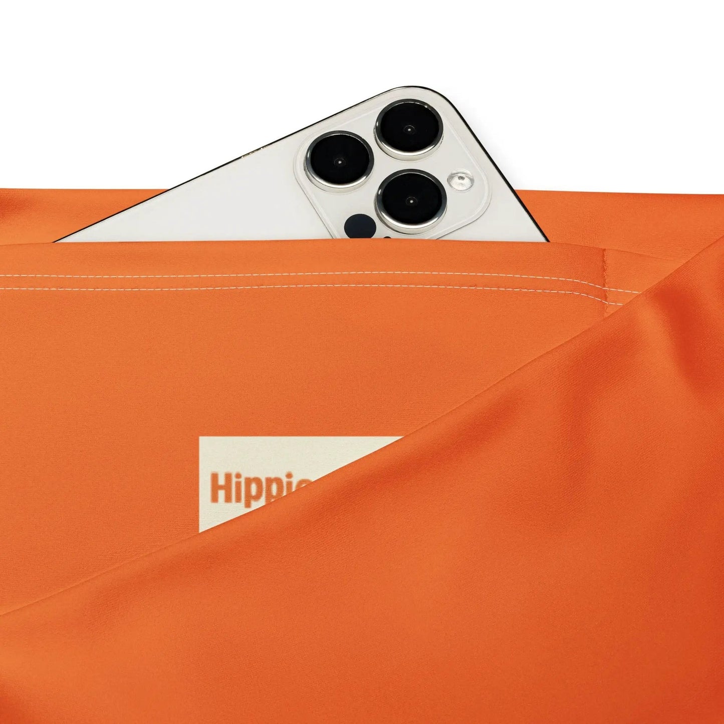 Orange activewear leggings side pocket holding smartphone