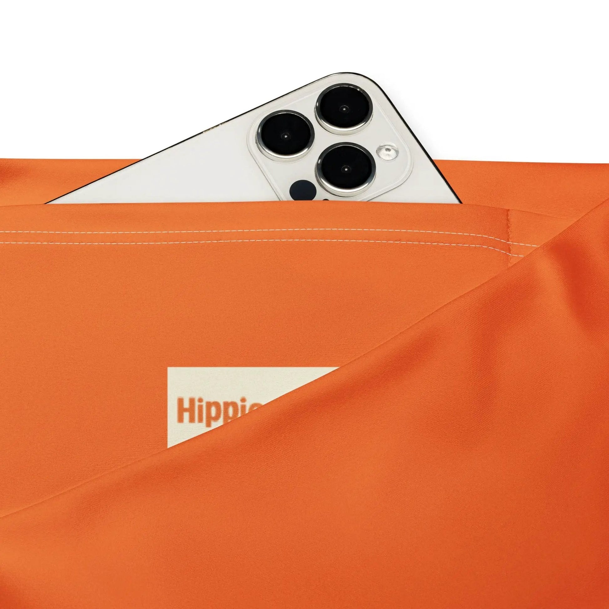 Orange activewear leggings side pocket holding smartphone