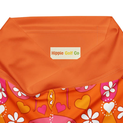 Inside waistband tag reading Hippie Golf Co on orange leggings