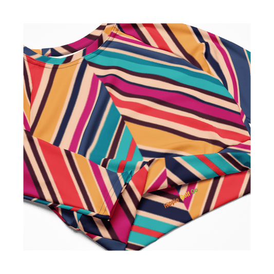 Close-up of Hippie Golf Co logo on teal magenta striped performance crop top