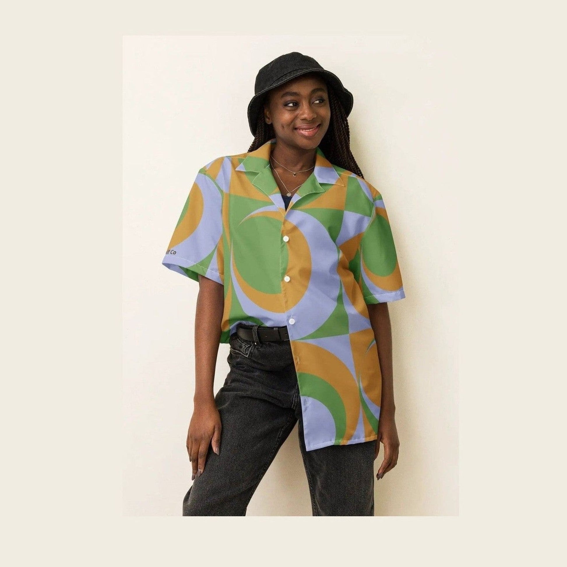 Full body shot of model in oversized geometric print button shirt with white buttons
