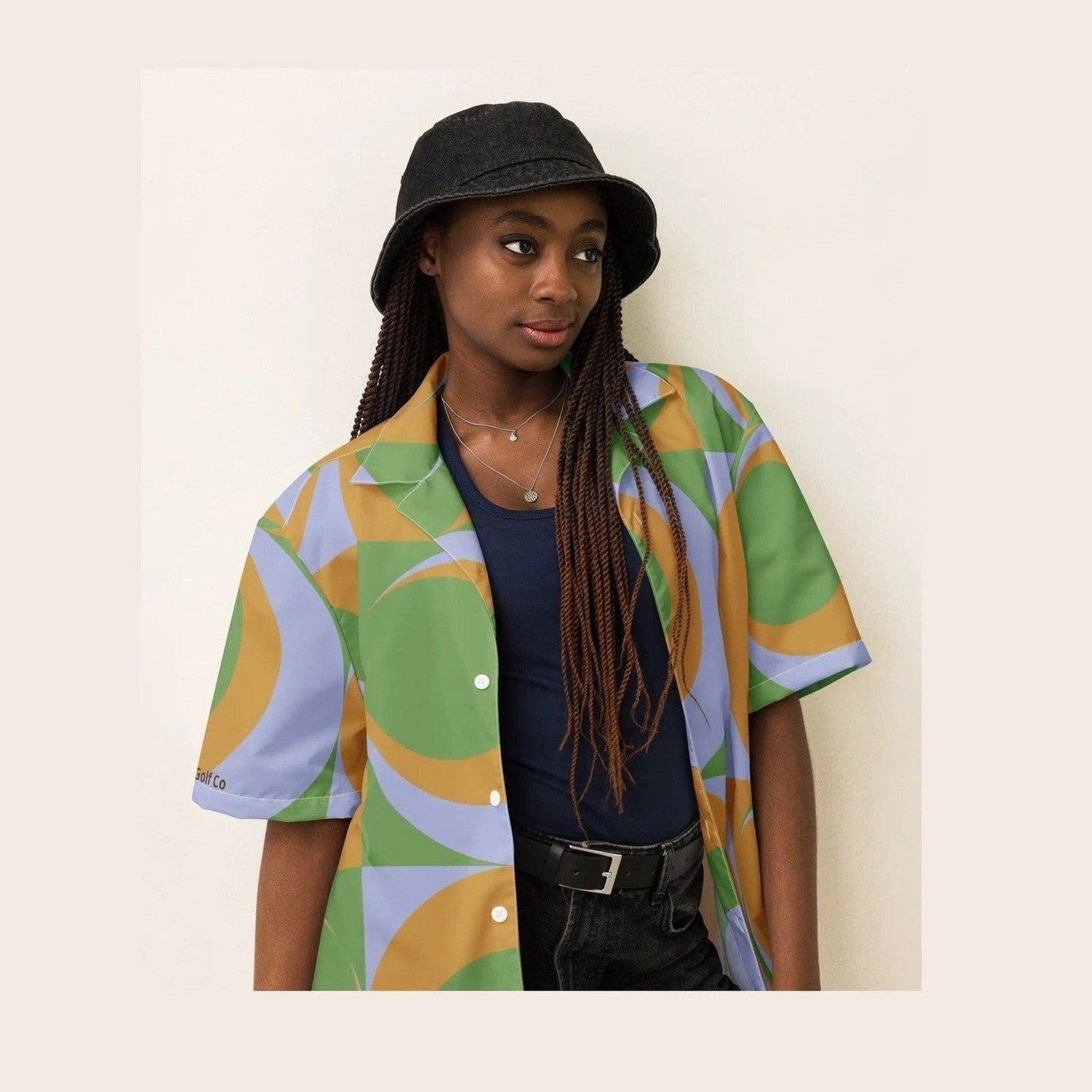Model wearing Hippie Golf Co oversized geometric print button-up shirt with bucket hat