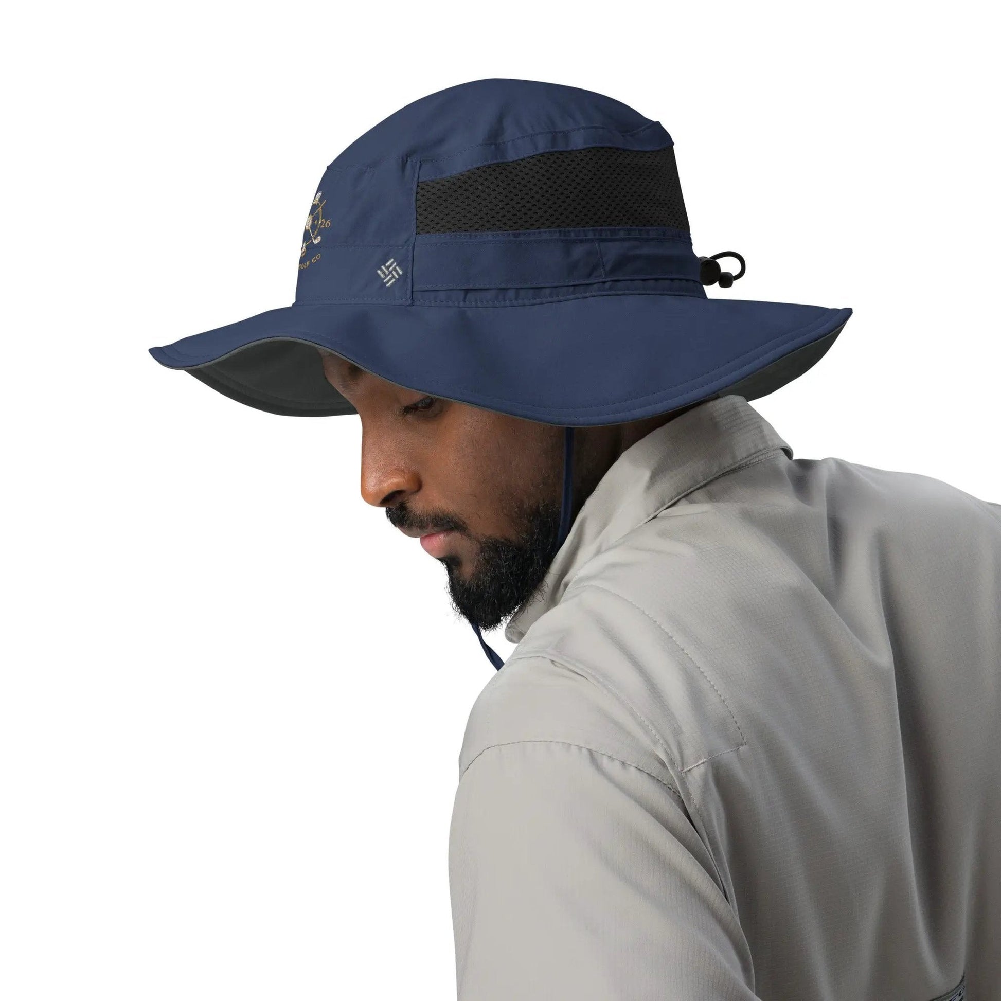 Man wearing navy Columbia Booney Hat highlighting structured crown and adjustable chin strap