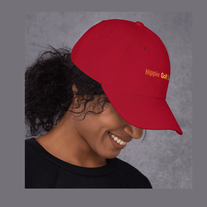Red dad hat worn on head casting shadow over eyes