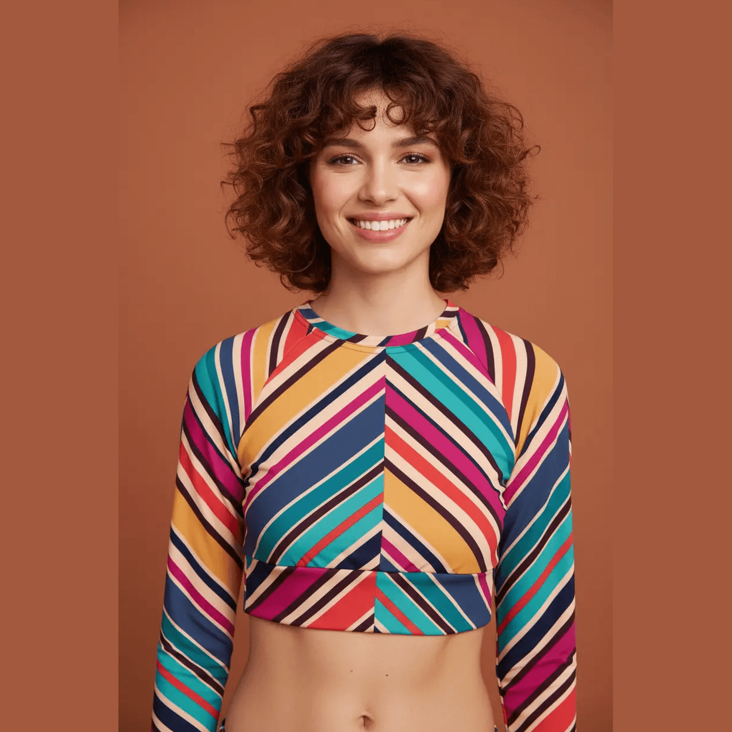 Close-up of teal orange pink navy cream chevron striped recycled long-sleeve crop top with raglan sleeves