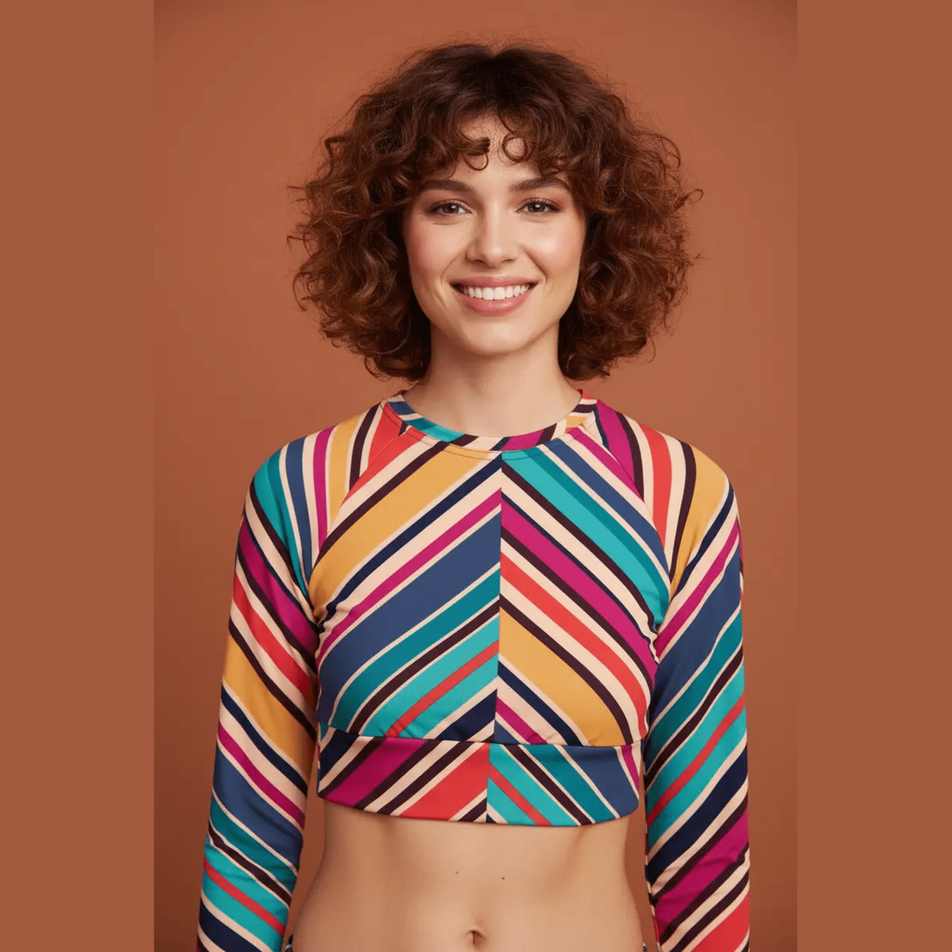 Close-up of teal orange pink navy cream chevron striped recycled long-sleeve crop top with raglan sleeves