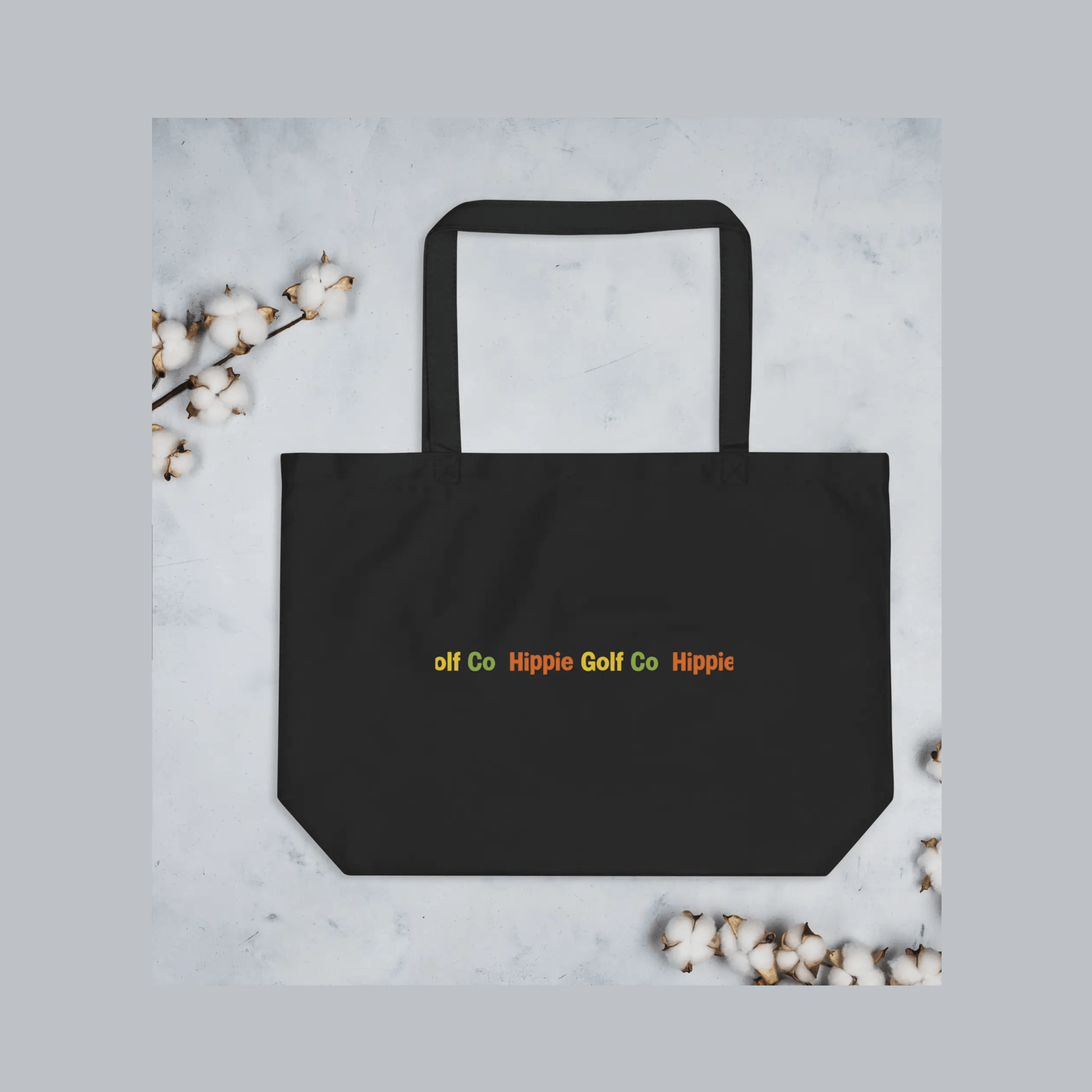 Large Eco Peace Tote in black organic cotton with multicolored Hippie Golf Co text and flat bottom
