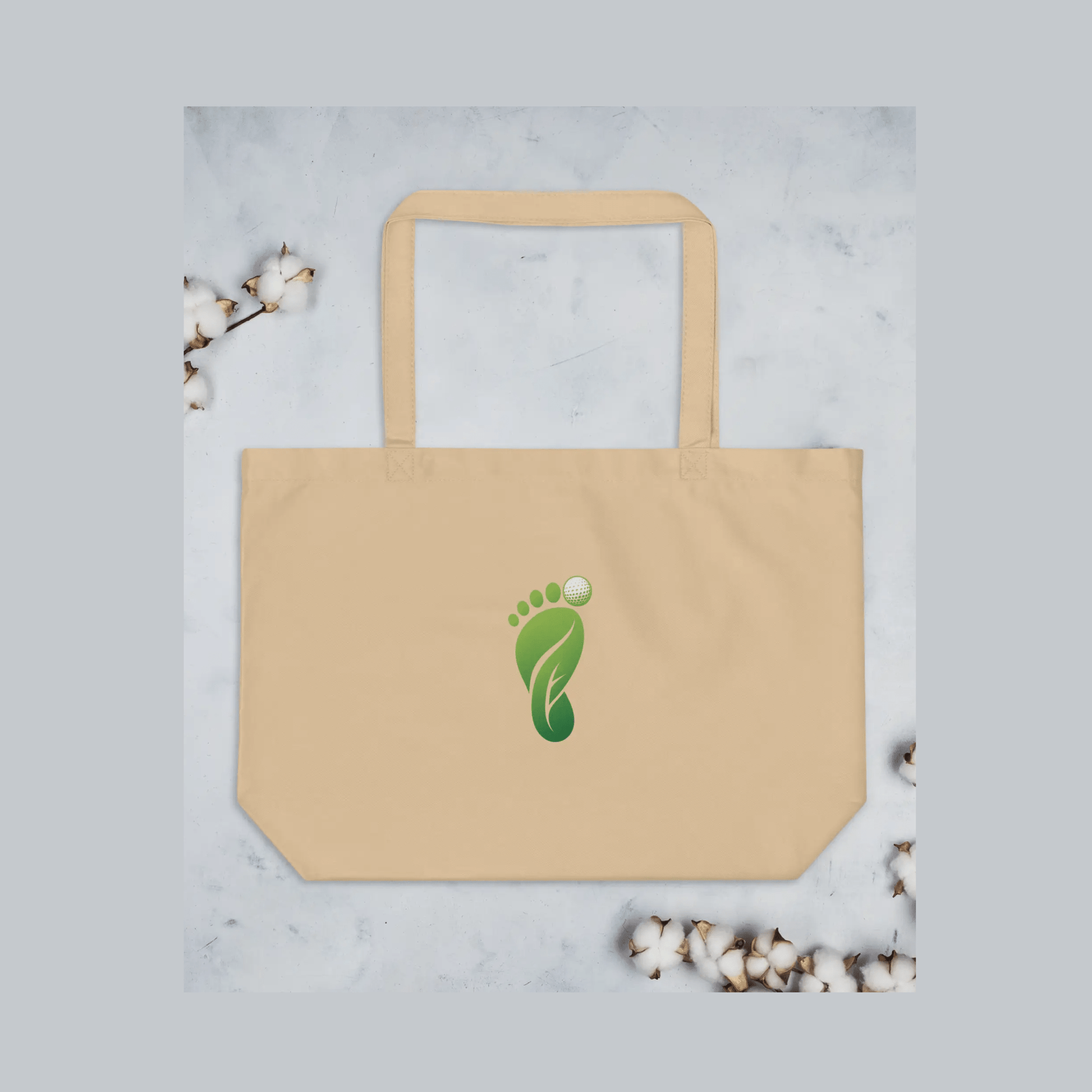 Beige organic cotton tote bag featuring green foot logo with golf ball icon and dual straps