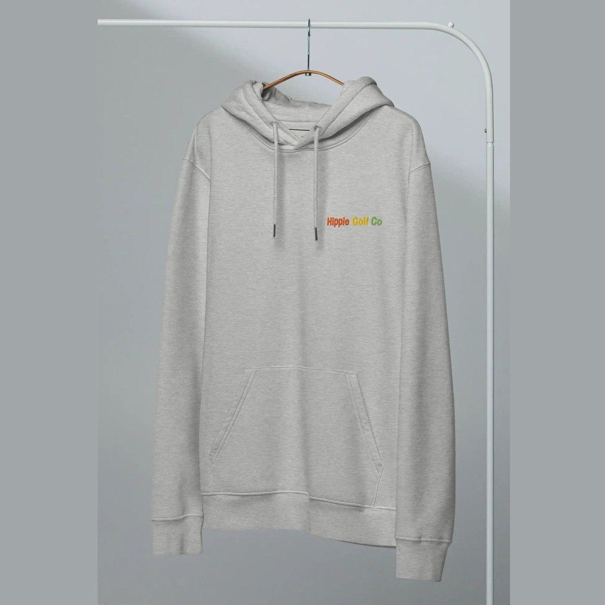 Hanging heather grey unisex hoodie with neutral background and relaxed silhouette